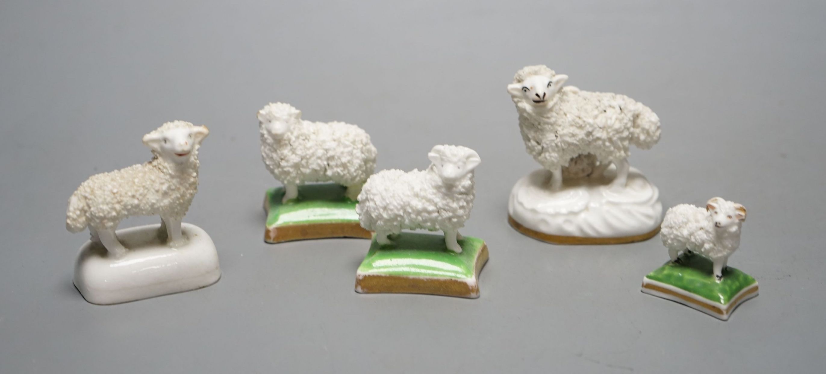 Five Staffordshire porcelain toy models of sheep, c.1830–50, including a pair of a ewe and a ram with green and gilt bases. Provenance: Dennis G. Rice collection, largest 6 cms high.